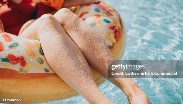 legs in a rubber ring - ring swimming pool stock pictures, royalty-free photos & images