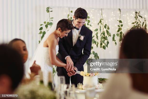 the sweetest tradition of a wedding - cutting cake stock pictures, royalty-free photos & images