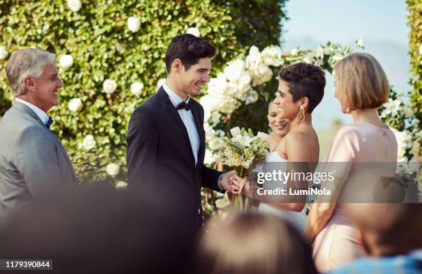 celebrating their union surrounded by family - wedding vows stock pictures, royalty-free photos & images