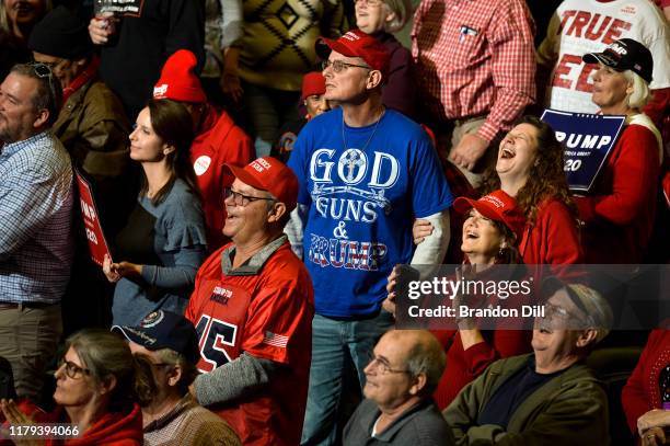 Supporters react to President Donald Trump during a "Keep America Great" campaign rally at BancorpSouth Arena on November 1, 2019 in Tupelo,...