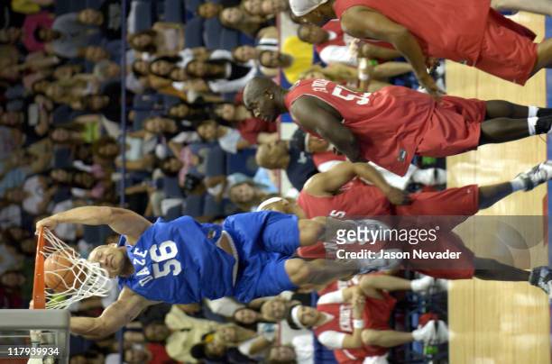 Brian Urlacher of the Chicago Bears slams dunks the basketball while Greg Favors of the Jacksonville Jaguars watches