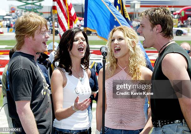 Country group Little Big Town sings the National Anthem during the CarQuest Auto Parts 300 pre-race.