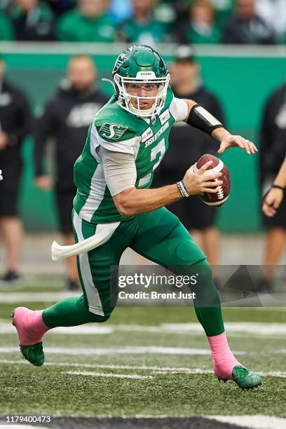 Cody Fajardo of the Saskatchewan Roughriders scrambles with the ball in the game between the Winnipeg Blue Bombers and Saskatchewan Roughriders at...