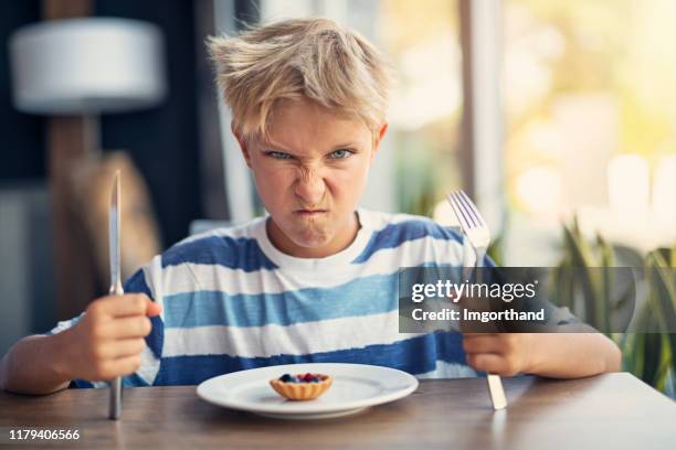 little boy angry with too small cake - portion stock pictures, royalty-free photos & images