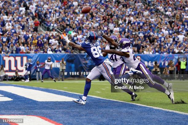 Darius Slayton of the New York Giants catches a 35 yard touchdown pass thrown by Daniel Jones against Xavier Rhodes and Anthony Harris of the...