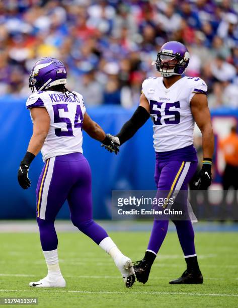 Eric Kendricks and Anthony Barr of the Minnesota Vikings high five during the first half of their game against the New York Giants at MetLife Stadium...