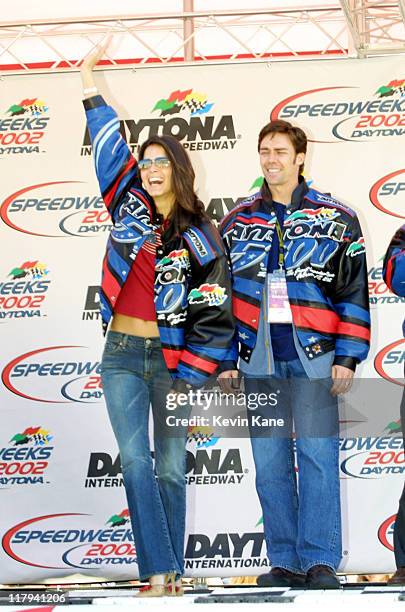 Actress Angie Harmon waves to the crowd as husband Jason Sehorn looks on