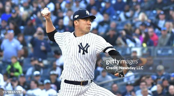 New York Yankees starting pitcher Masahiro Tanaka delivers a pitch in the 1st inning against Minnesota Twins at Game 2 of the American League...