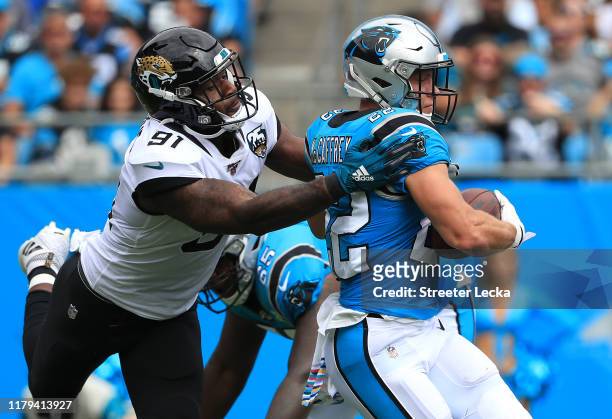 Yannick Ngakoue of the Jacksonville Jaguars tries to sotp Christian McCaffrey of the Carolina Panthers during their game at Bank of America Stadium...