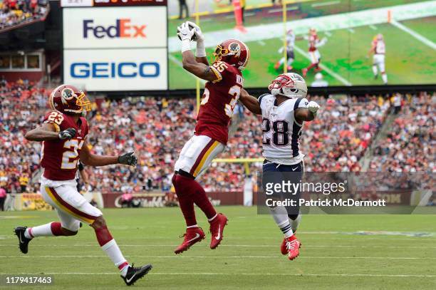 Montae Nicholson of the Washington Redskins intercepts a ball intended for James White of the New England Patriots during the second quarter in the...