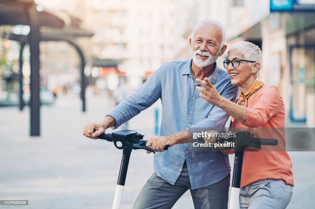 Senior couple with e-scooters