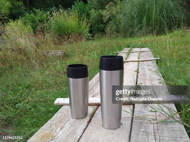 two stainless steel thermos bottles - reusable coffee cup stock pictures, royalty-free photos & images