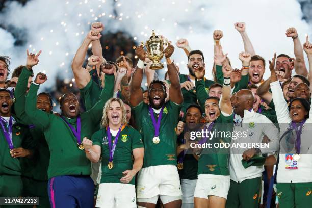 South Africa's flanker Siya Kolisi lifts the Webb Ellis Cup as they celebrate winning the Japan 2019 Rugby World Cup final match between England and...