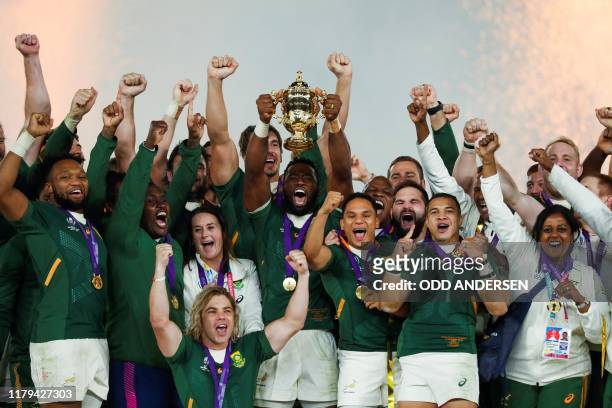 South Africa's flanker Siya Kolisi lifts the Webb Ellis Cup as they celebrate winning the Japan 2019 Rugby World Cup final match between England and...