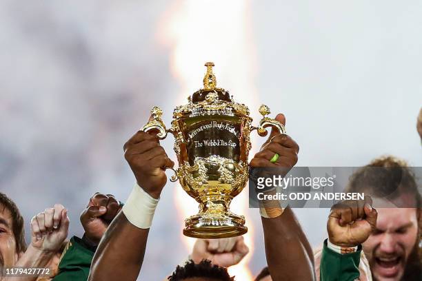 South Africa's flanker Siya Kolisi lifts the Webb Ellis Cup as they celebrate winning the Japan 2019 Rugby World Cup final match between England and...