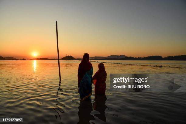 Hindu devotees offer prayers during the Chhat Puja Festival on the banks of the Brahmaputra river in Guwahati on November 02, 2019. The Chhath...