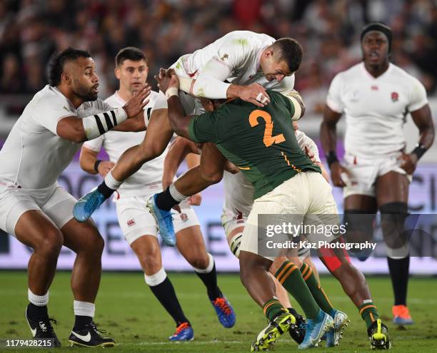 Mbongeni Mbonambi of South Africa tackles Jonny May of England during the Rugby World Cup 2019 Final between England and South Africa at...