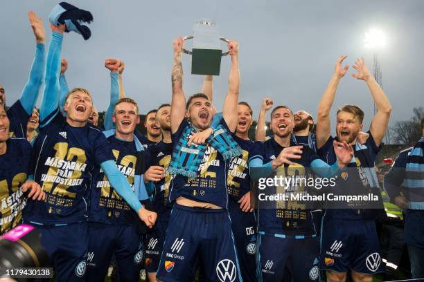 Astrit Ajdarevic of Djurgardens IF raises the Lennart Johansson trophy after Djurgardens IF wins the 2019 Allsvenskan season during an Allsvenskan...