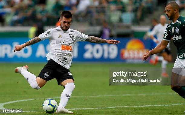 Nathan of Atletico MG kicks the ball to score the first goal of his team during a match between Palmeiras and Atletico MG for the Brasileirao Series...