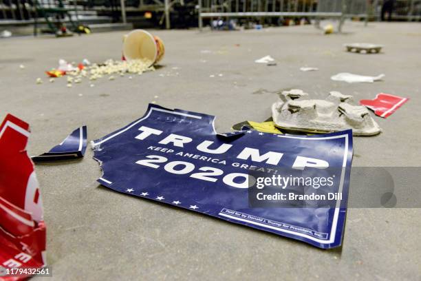 Torn sign lies on the ground after a "Keep America Great" campaign rally for President Donald Trump at BancorpSouth Arena on November 1, 2019 in...