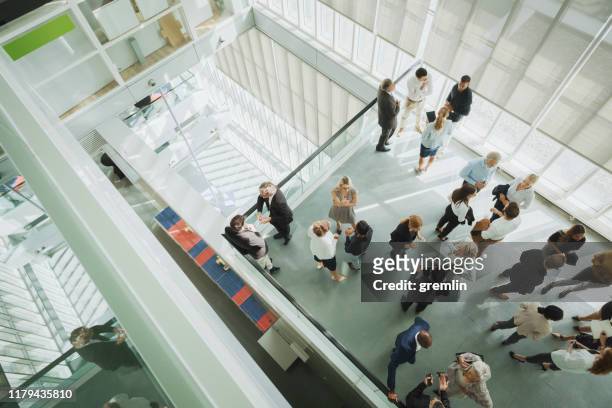 group of business people in convention center - cliqueimages stock pictures, royalty-free photos & images