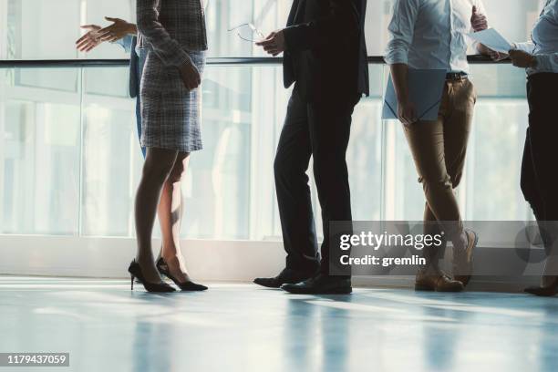legs of business people in convention center - group of businesspeople standing low angle view stock pictures, royalty-free photos & images