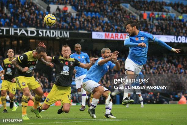 Manchester City's Spanish midfielder David Silva heads the ball during the English Premier League football match between Manchester City and...