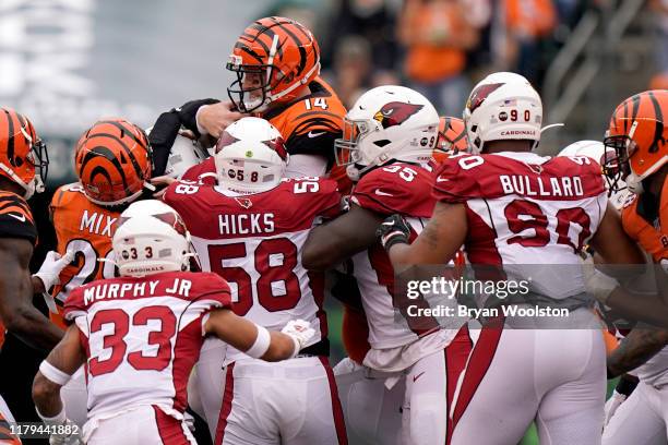 Andy Dalton of the Cincinnati Bengals is stopped at the line of scrimmage for a loss during the NFL football game against the Arizona Cardinals at...