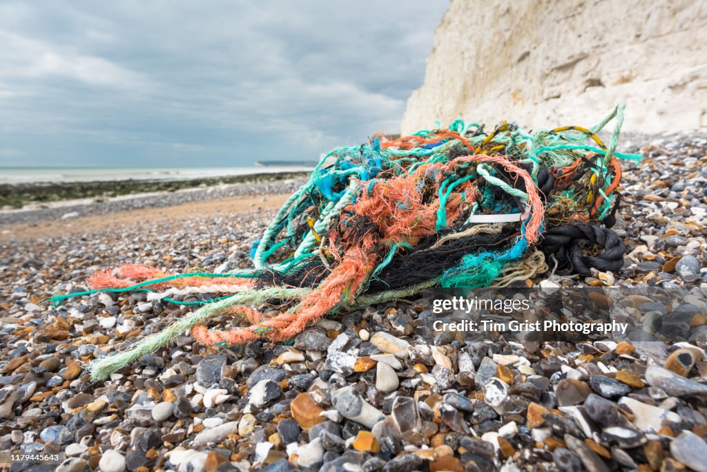 Tangled Plastic Rope And Old Fishing Nets Washed Up On The Empty