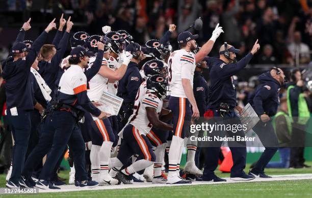 Matt Nagy, Head Coach of Chicago Bears celebrates with his team on the sideline during the game between Chicago Bears and Oakland Raiders at...