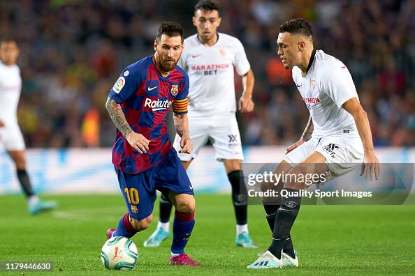 Lionel Messi of FC Barcelona competes for the ball with Diego Carlos
