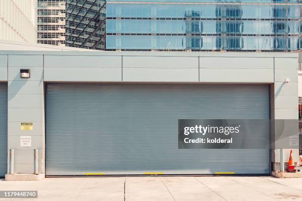 closed garage roller door - shop shutter stock pictures, royalty-free photos & images