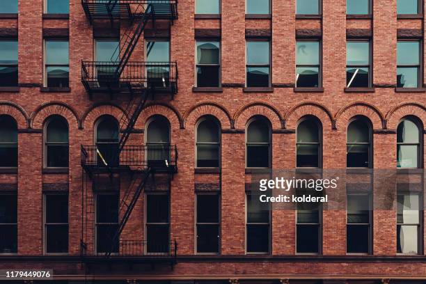 soho district apartment building , manhattan , new york - brick facade stock pictures, royalty-free photos & images