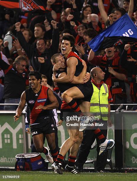 David Zaharakis and Angus Monfries of the Bombers celebrate a last quarter goal during the round 15 AFL match between the Essendon Bombers and the...