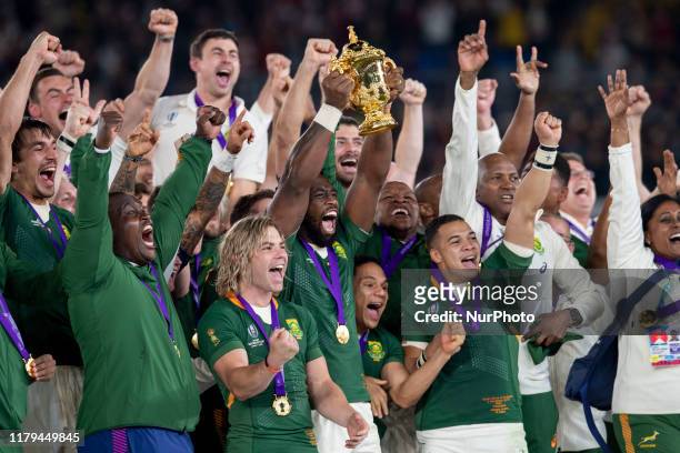 South Africa captain Siya Kolisi lifts the trophy with his team mates Faf de Klerk Herschel Jantjies and Cheslin Kolbe after the Rugby World Cup 2019...