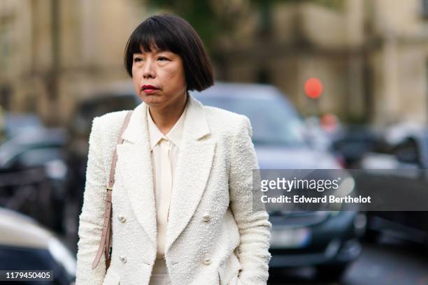 Angelica Cheung, Vogue China Editor-in-Chief, wears a white blazer jacket, a white shirt, a tie, outside Miu Miu, during Paris Fashion Week -...