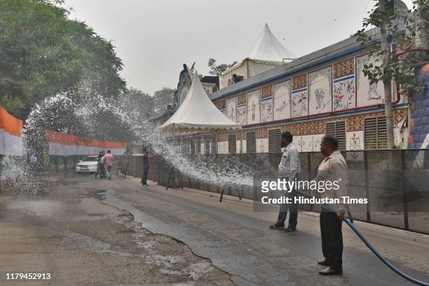 Workers spray water on trees and road pavements a day before of the first T20 international cricket match between India and Bangladesh, outside Arun...