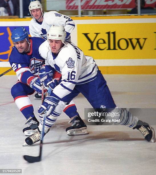 Darby Hendrickson of the Toronto Maple Leafs skates against Teppo Numminen of the Winnipeg Jets during NHL game action on November 18, 1995 at Maple...