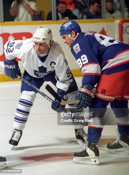 Doug Gilmour of the Toronto Maple Leafs skates against Darren Turcotte of the Winnipeg Jets during NHL game action on November 18, 1995 at Maple Leaf...