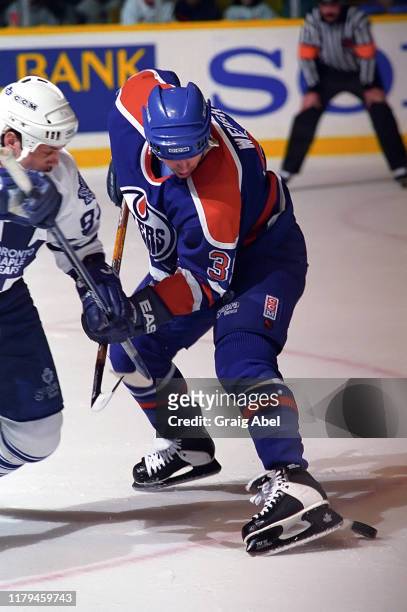Doug Weight of the Edmonton Oilers skates against Doug Gilmour of the Toronto Maple Leafs during NHL game action on December 23, 1995 at Maple Leaf...