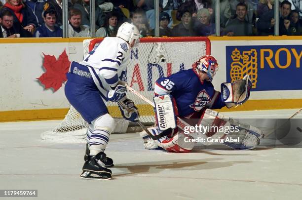 Nikolai Khabibulin of the Winnipeg Jets skates against Randy Wood of the Toronto Maple Leafs during NHL game action on November 18, 1995 at Maple...