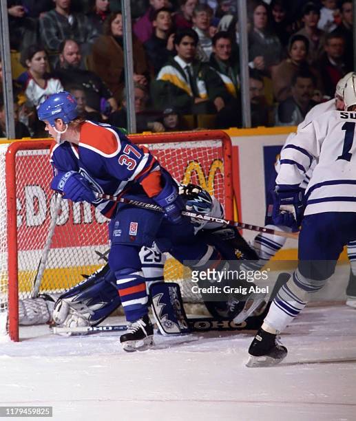 Dean McAmmond of the Edmonton Oilers skates against Felix Potvin of the Toronto Maple Leafs during NHL game action on December 23, 1995 at Maple Leaf...