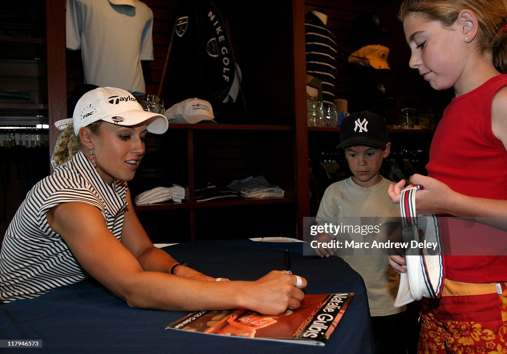 Natalie Gulbis signs her new 16month 2005 calendar on July 9th, 2004