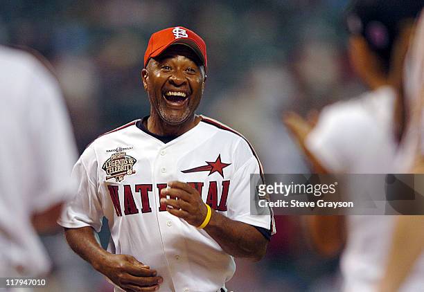 Ozzie Smith is greeted at home plate by teamates after a homerun during the Legends and Celebrities softball game at Minute Maid Park in Houston,...