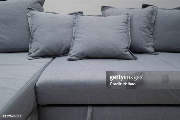 color cushion on grey fabric sofa - cushion imagens e fotografias de stock