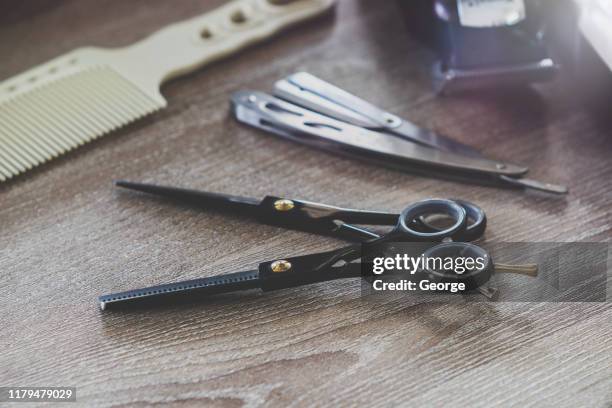 close-up of scissors on wood table at barber shop - hairdresser tools stock pictures, royalty-free photos & images