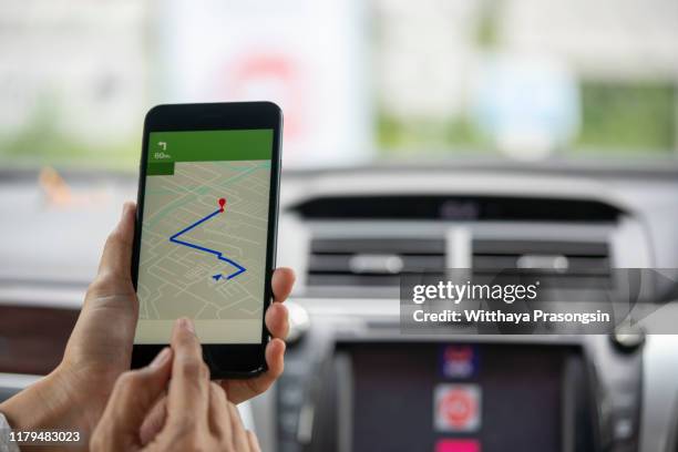 mobile phone with map gps navigation in car. toned at sunset - global positioning system stock pictures, royalty-free photos & images