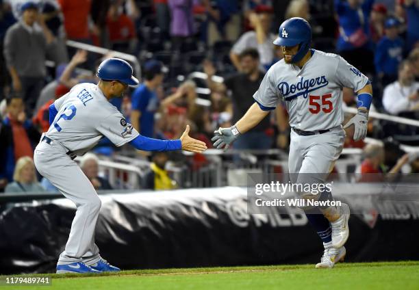 Russell Martin of the Los Angeles Dodgers celebrates with third base coach Dino Ebel after hitting a two run home run in the ninth inning of Game 3...