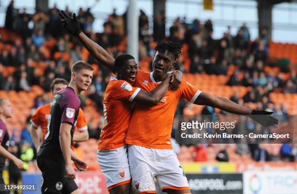 Blackpool's Armand Gnanduillet celebrates scoring his side's third goal with team-mate Sullay Kaikai during the Sky Bet League One match between...