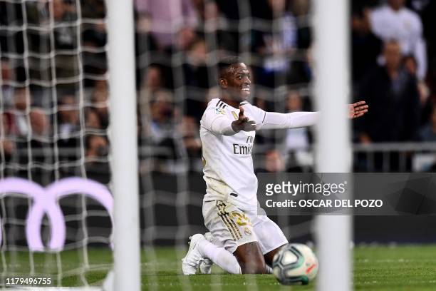 Real Madrid's Brazilian forward Vinicius Junior reacts after missing a goal opportunity during the Spanish League football match between Real Madrid...
